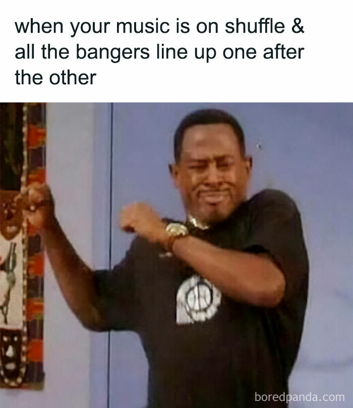 Man dancing with eyes closed, enjoying music shuffle, capturing the vibe of nostalgic ’90s posts and memes.