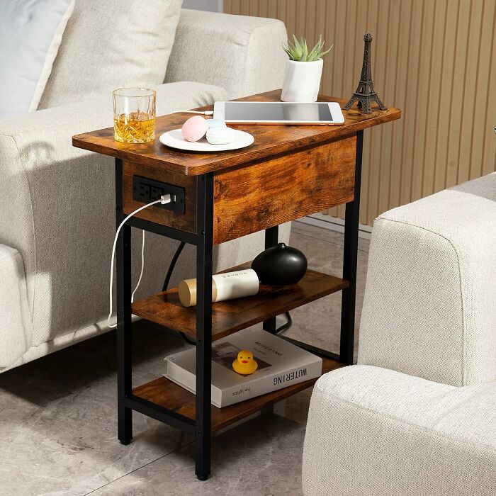 Wooden side table with shelves and charging station between sofas, creating a happy place in your home environment.