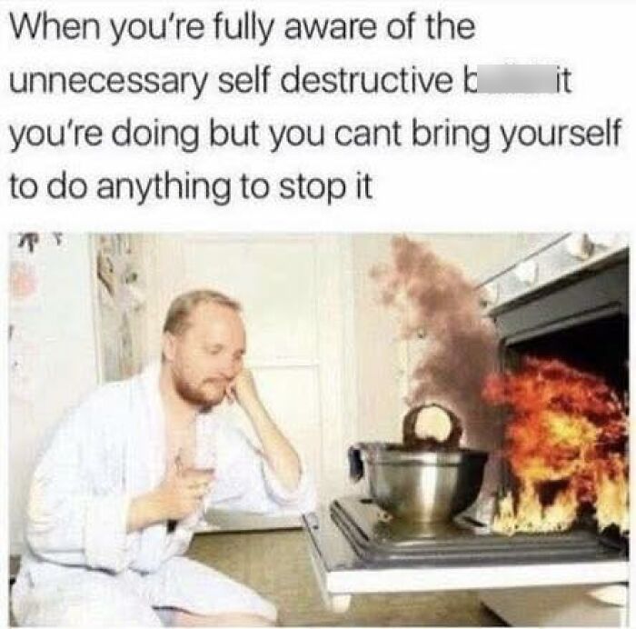 Man in robe calmly watching pot on stove catching fire, illustrating self destructive behavior in funny pics for mental breakdowns.