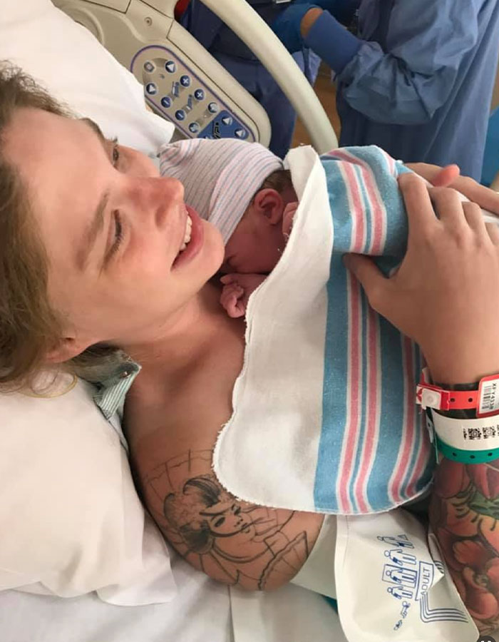 Mother holding newborn baby wrapped in hospital blanket, related to babysitter fatal Benadryl dose case for 7-month-old baby.