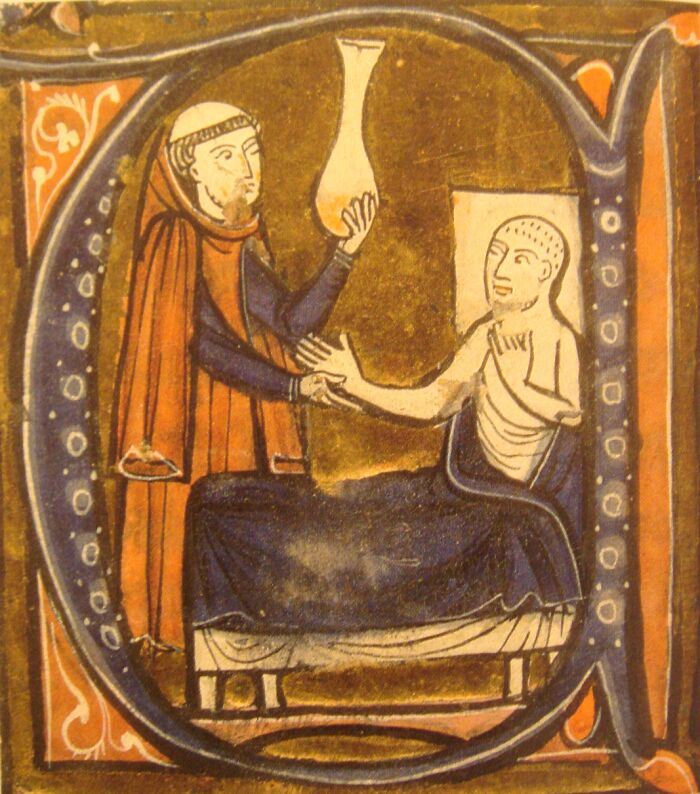 Medieval illustrated manuscript showing a healer holding a glass vessel over a patient in a historical artifact.