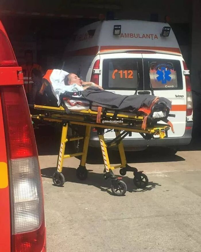 Patient lying on a stretcher outside an ambulance, highlighting moments when medicine crosses into the uncanny.