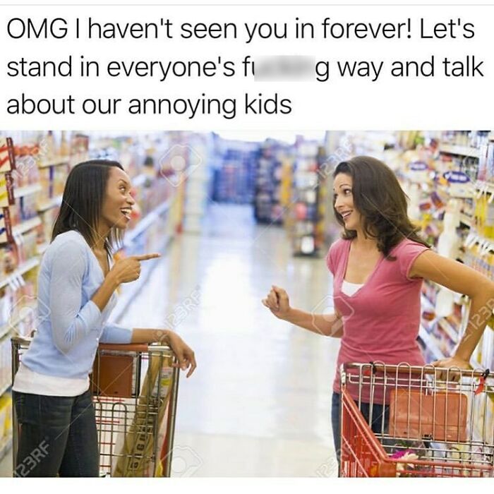 Two women with shopping carts laugh and chat about parenting in a grocery store, sharing funny parenting memes.