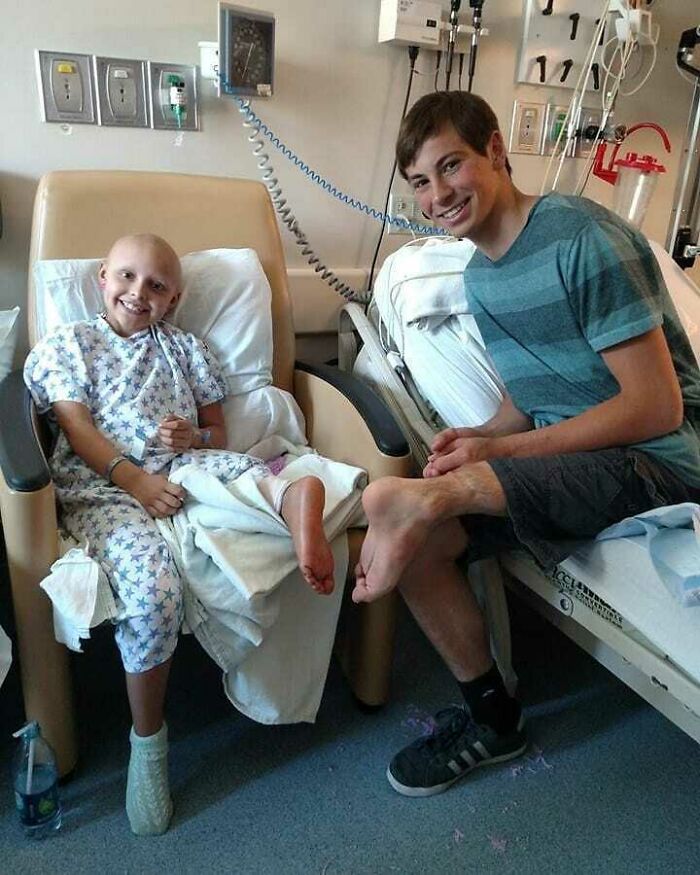 Two boys in a hospital room, one in a patient gown and the other showing his foot, highlighting moments when medicine crossed the uncanny.
