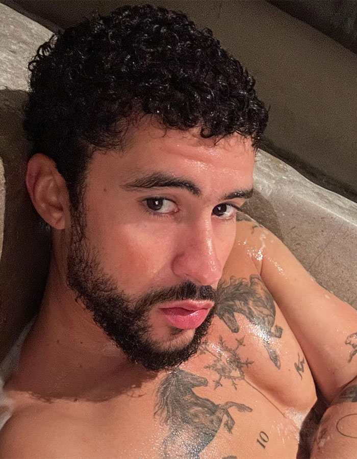 Bad Bunny close-up selfie showing tattoos and wet skin, making fans go wild with revealing underwear look.