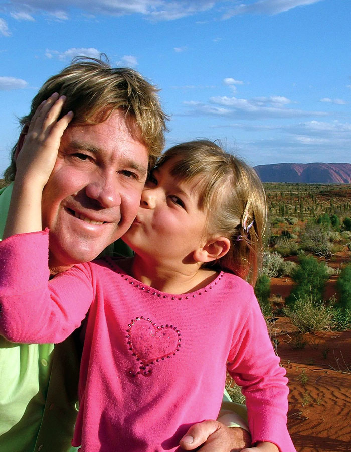 Bindi Irwin shares health update from hospital after medical emergency related to incurable disease outdoors in natural setting.