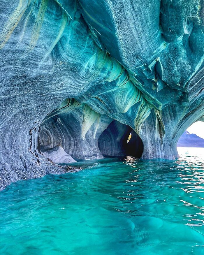 Turquoise water flowing through stunning marble caves showcasing rare natural phenomena in a breathtaking natural landscape.