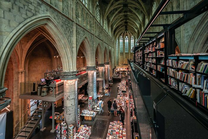 Interior view of a stunning bookstore inside a historic building with arched ceilings and impressive book displays.