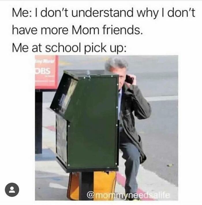 Parent using a newspaper box for cover at school pickup, illustrating funny parenting memes that are painfully relatable.