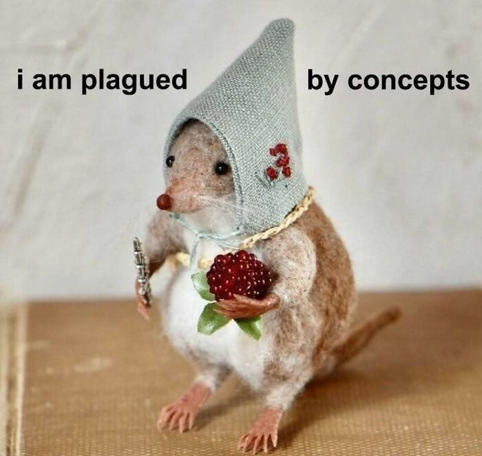 Felt mouse figurine meme holding berries, wearing a bonnet, illustrating relatable memes and humor concepts.