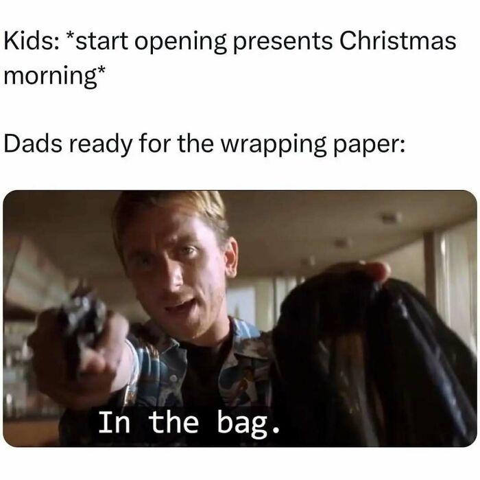 Man holding a gun and a black bag ready to catch wrapping paper in a funny totally random meme.