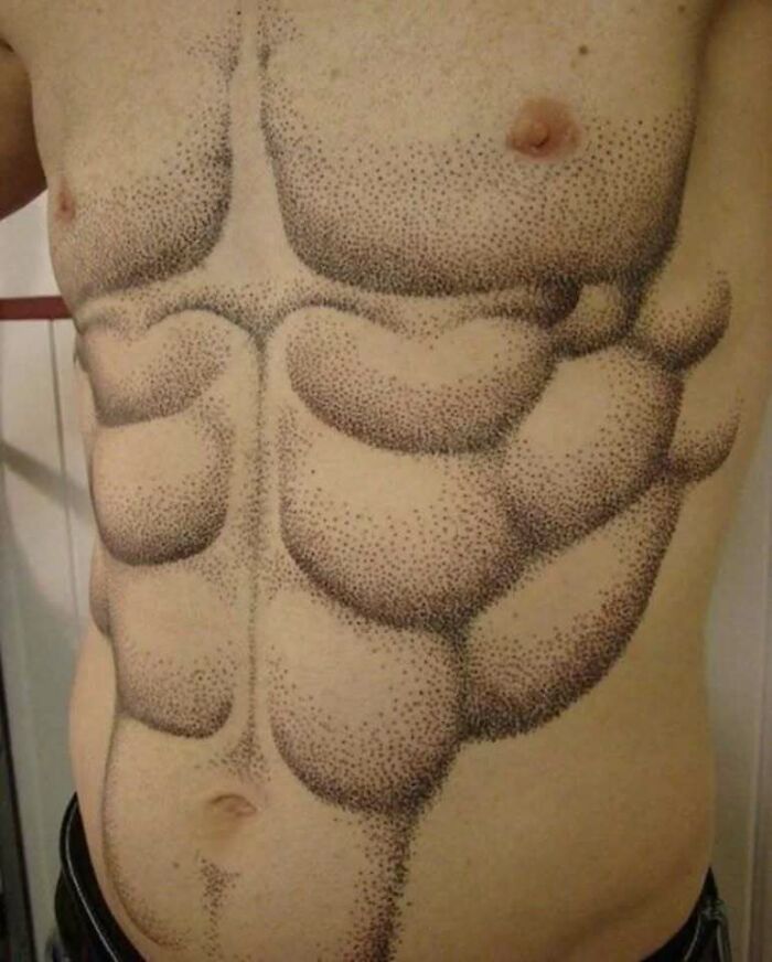 Tattoo of exaggerated and uneven abs on a bare torso, showcasing a funny and interesting tattoo design.