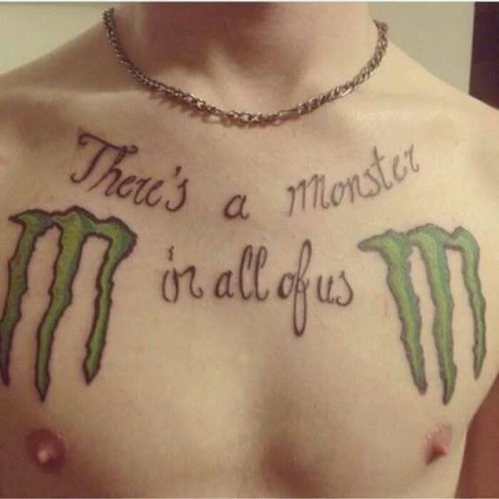 Chest tattoo featuring the phrase there's a monster on all of us with two green monster claw designs on each side.