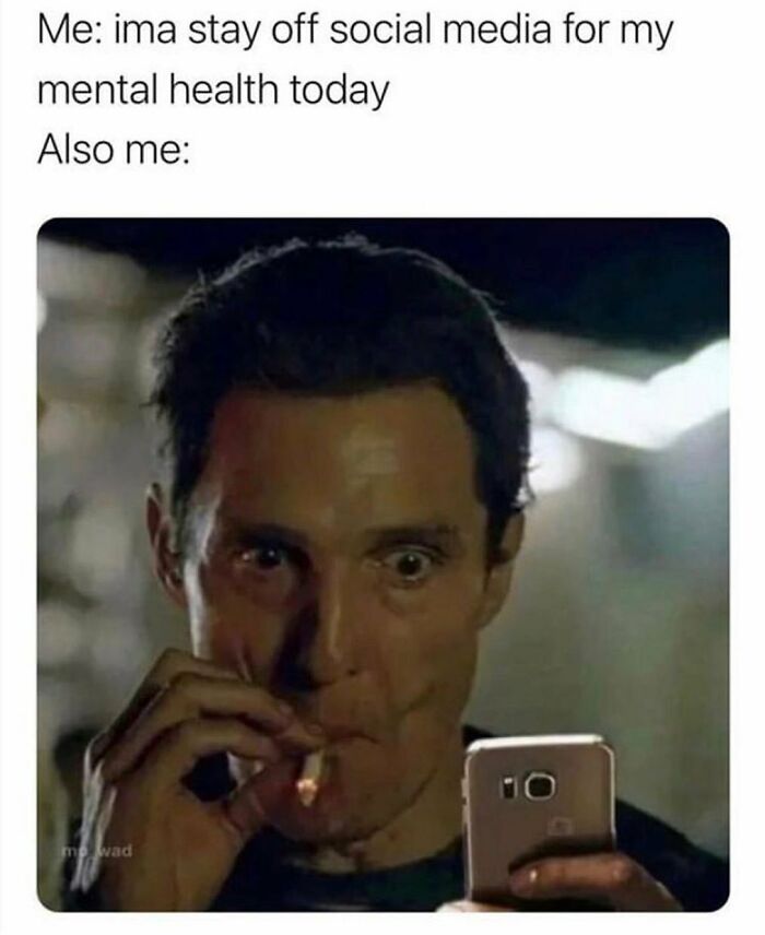 Man with wide eyes smoking a cigarette while looking at a phone, illustrating funny parenting memes that are painfully relatable.