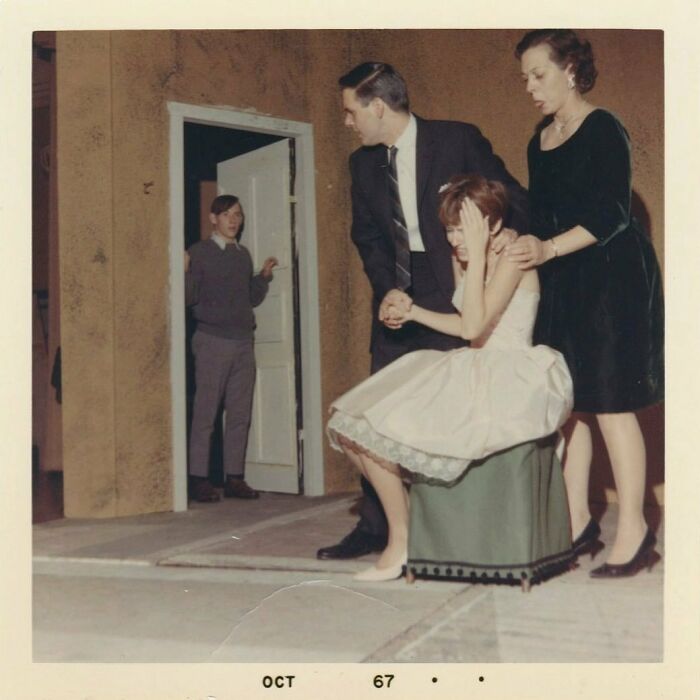 Vintage photo from 1967 showing a distressed young woman supported by two adults with another person in the background.