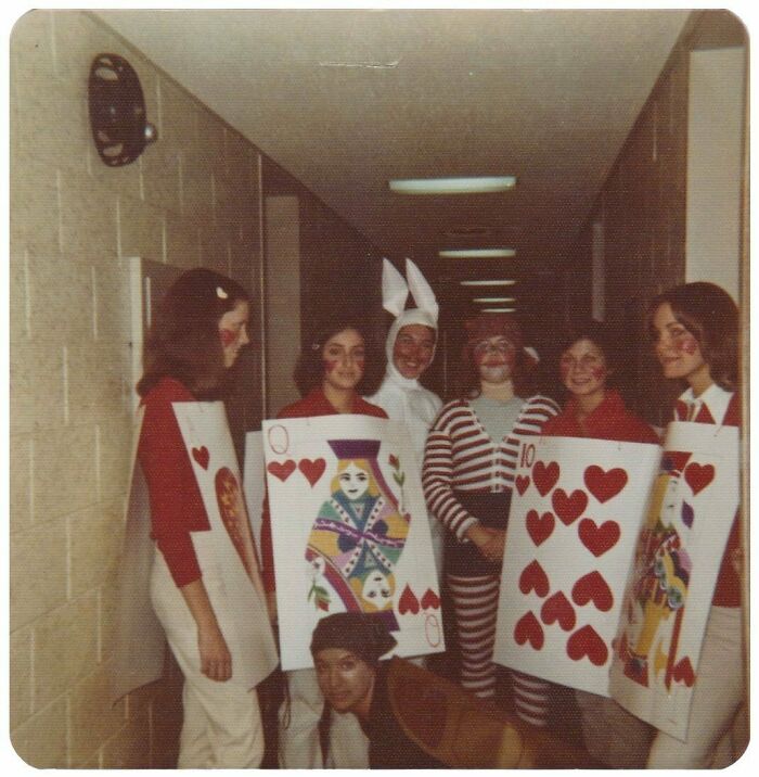 Group of people in vintage costumes including playing cards and a white rabbit, reflecting mesmerizing vintage photos history.