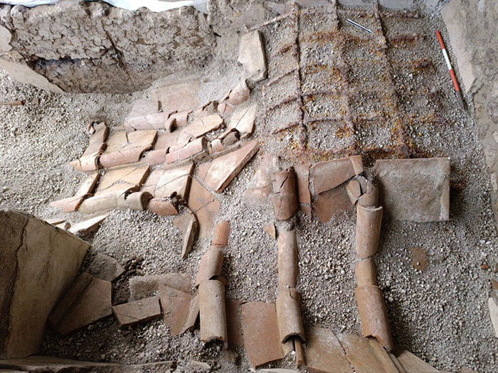 Archaeological site in Pompeii revealing remains linked to parents' tragic attempt to shield child during eruption.