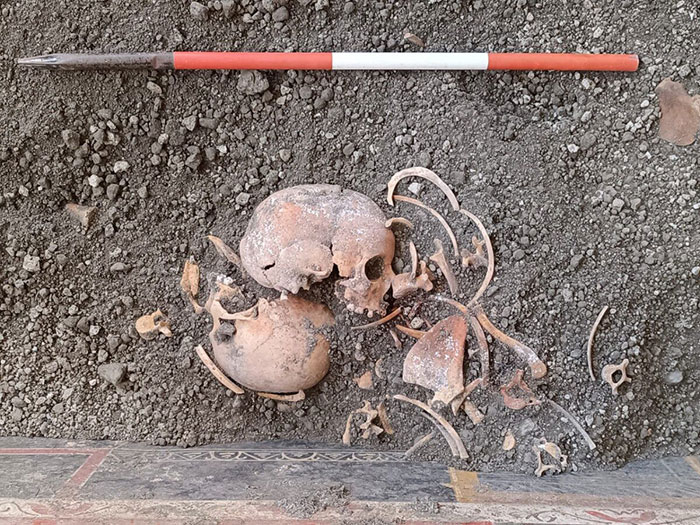 Pompeii discovery of ancient skeletal remains revealing parents' tragic attempt to shield child during eruption.