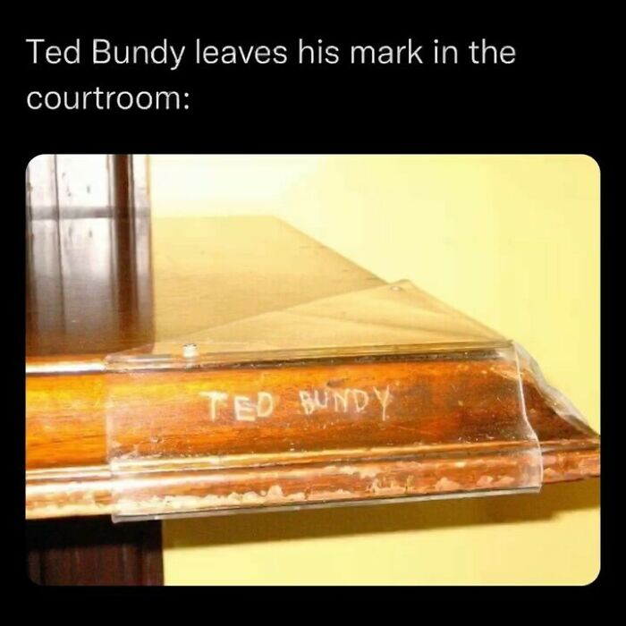 Carved name Ted Bundy on courtroom wooden surface, highlighting disturbing and unsettling events that actually happened.