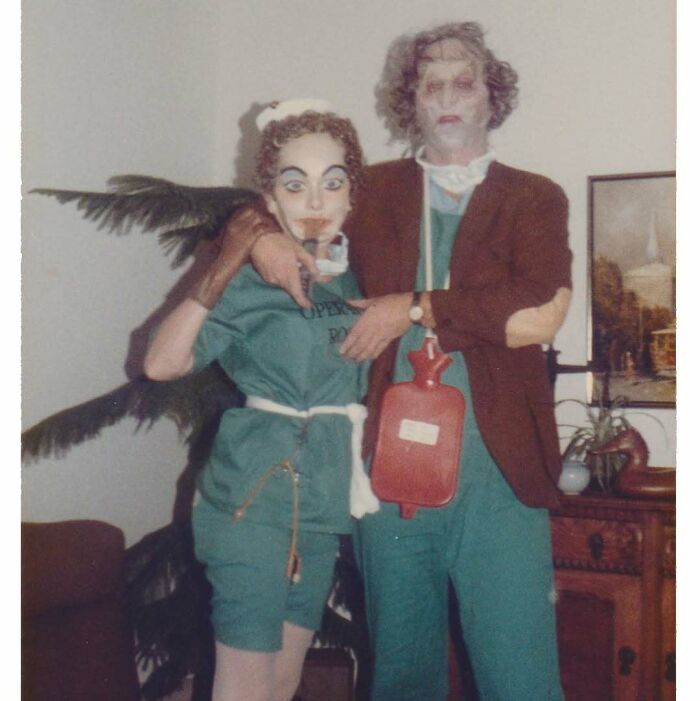 Vintage photo of two people in quirky costumes, showcasing an interesting and mesmerizing moment from history.