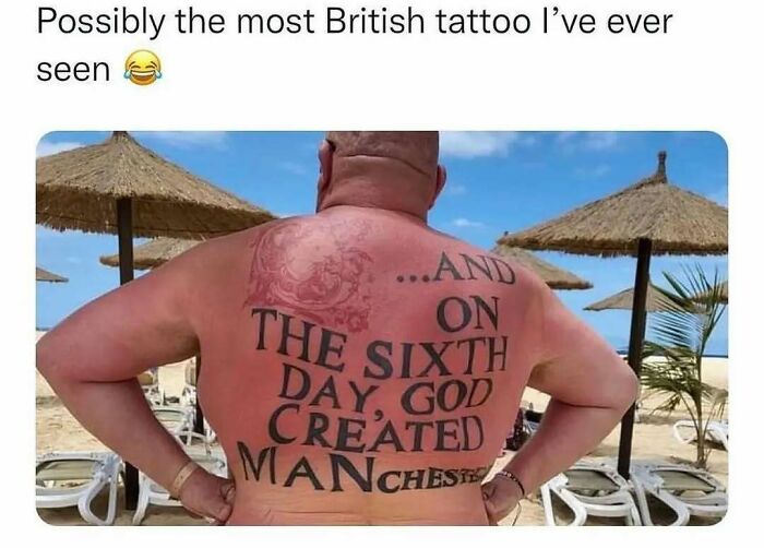 Man with a large funny tattoo on his sunburned back at the beach featuring a humorous religious text and city name.