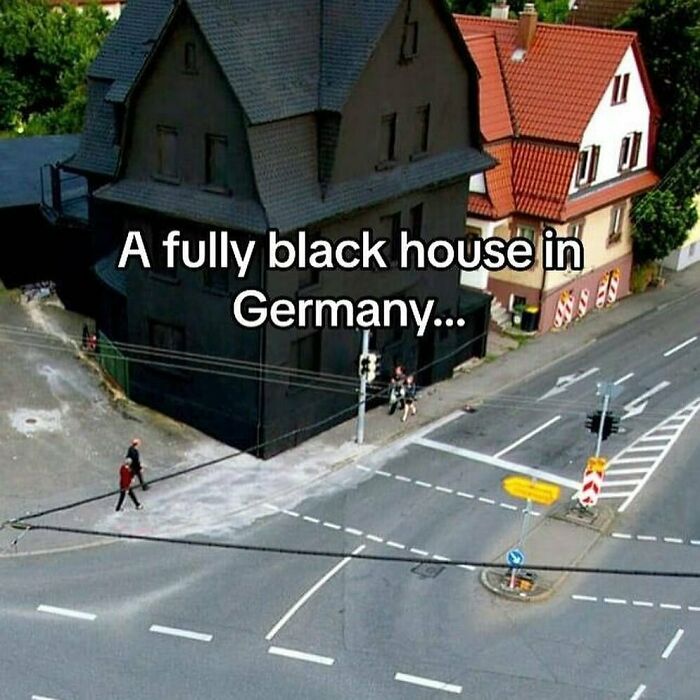 A fully black house in Germany at a street intersection, showcasing unique and interesting architectural features.