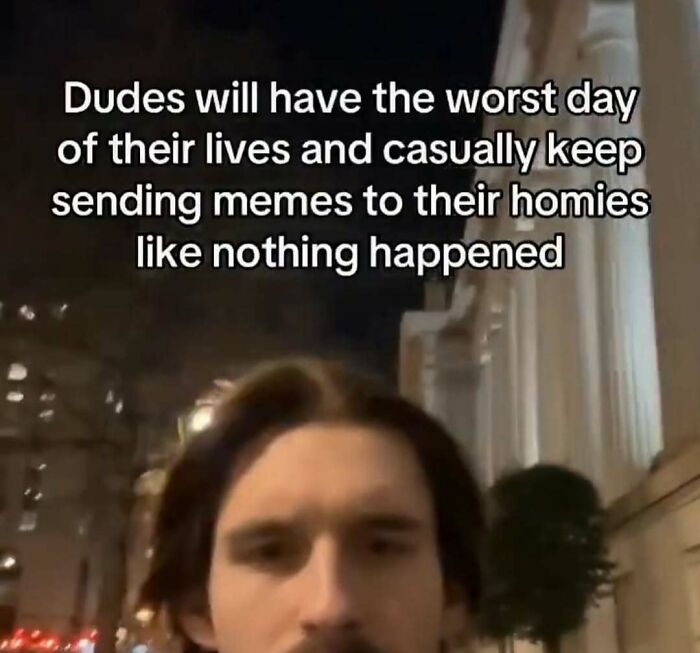 Young man with dark hair in city at night with meme text about sending funny relatable memes to friends.