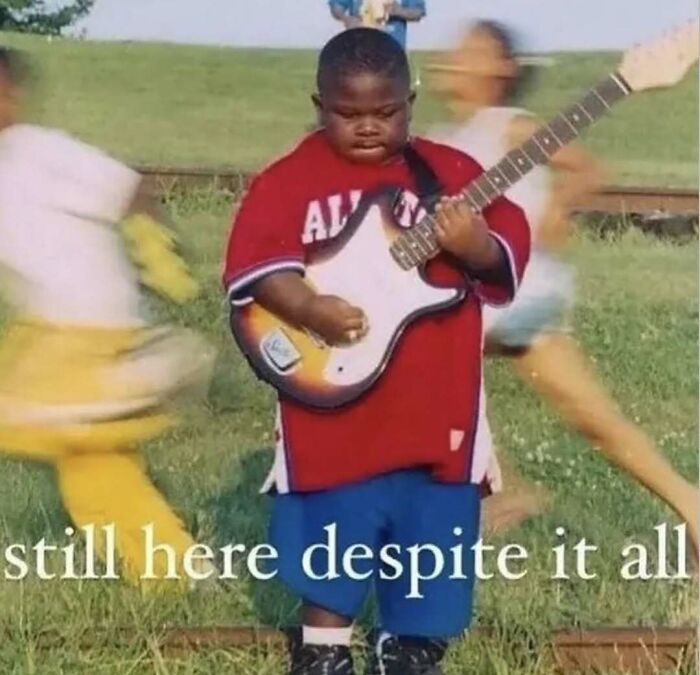 Child playing electric guitar outdoors with blurred children running past, relatable memes capturing humorous moments.