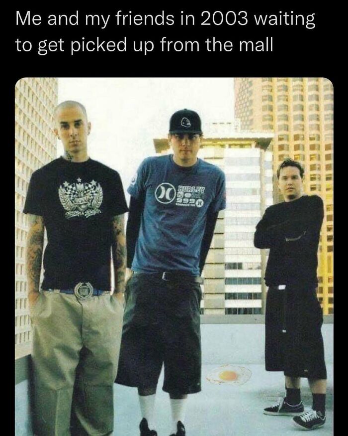 Three young men in early 2000s fashion posing outdoors in front of city buildings, a meme reflecting millennial humor.