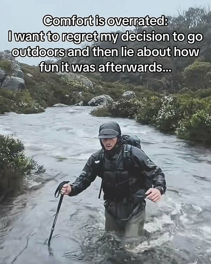 Man wading through river in hiking gear with funny relatable meme about regretting going outdoors from Instagram account.