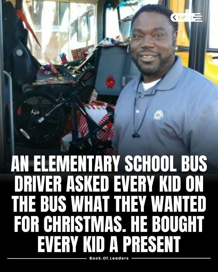 Smiling bus driver stands inside a bus filled with gifts, showing kindness in stories and facts that teach something new.