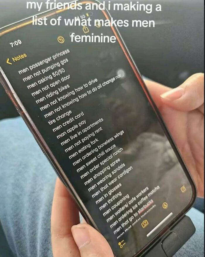 Person holding phone displaying a cringey Instagram note listing traits that make men appear feminine.