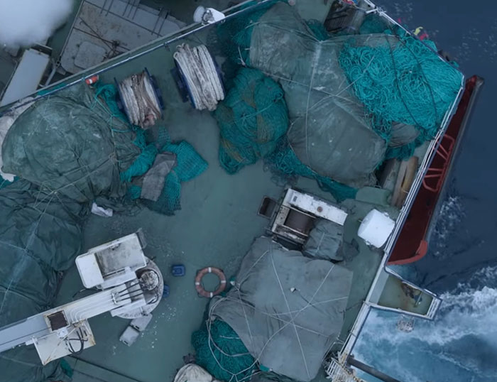 Fishing nets and equipment on a boat deck, highlighting environmental concerns from David Attenborough's urgent warning.