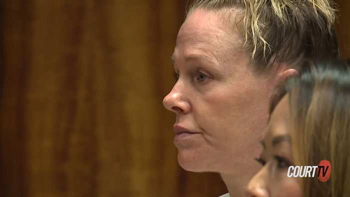 Woman in courtroom during judge's announcement of babysitter's fate in fatal Benadryl dose case involving infant.