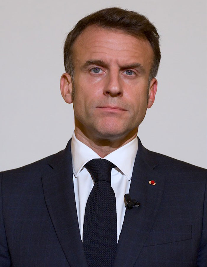 Emmanuel Macron in a dark suit and tie, addressing the public amid grooming rumors linked to teacher-student past controversy. Emmanuel Macron in a dark suit and tie, addressing the public amid grooming rumors linked to teacher-student past controversy.