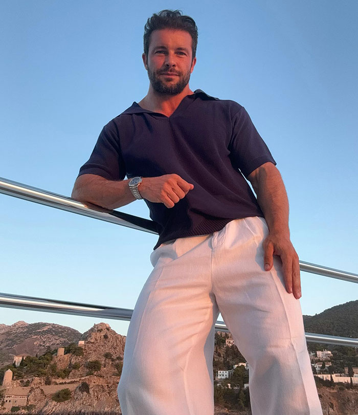 Male hair stylist flaunting body in stylish speedo on yacht with scenic Cannes background at sunset. Male hair stylist flaunting body in stylish speedo on yacht with scenic Cannes background at sunset.