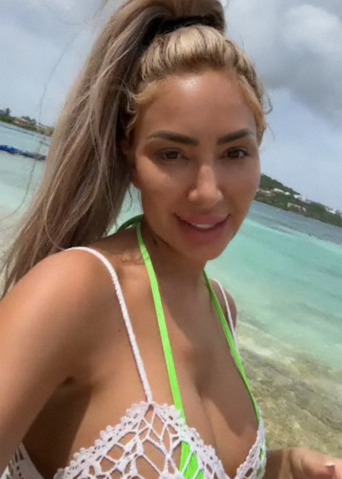 Farrah Abraham posing in a tiny neon green bikini during a beach photoshoot with ocean and hills in the background.