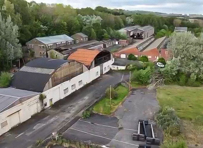 Aerial view of an industrial park with warehouses and greenery after a fire linked to arrests of 14 children. Aerial view of an industrial park with warehouses and greenery after a fire linked to arrests of 14 children.