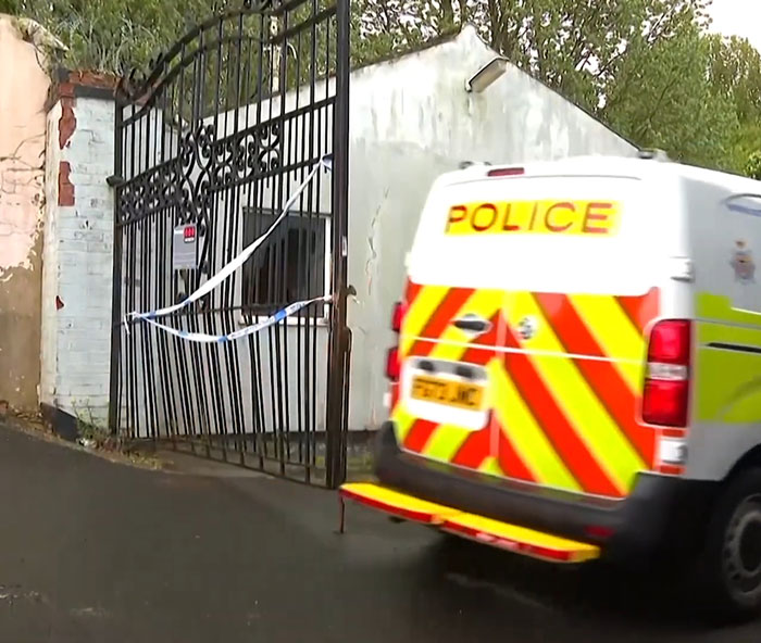 Police van parked near a taped off industrial park gate during investigation of missing boy's body found after fire. Police van parked near a taped off industrial park gate during investigation of missing boy's body found after fire.