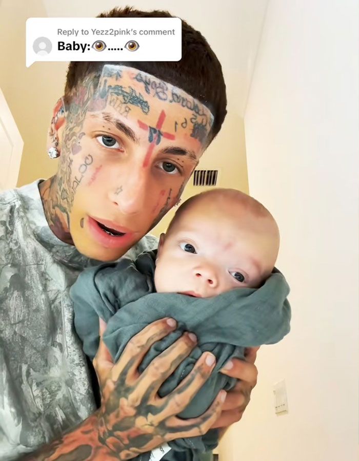 Island Boy holding his baby, responding to fans bullying his baby in a series of emotional videos.
