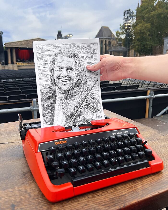 Red typewriter with detailed portrait drawing created by a young artist using a typewriter on a sheet of paper.