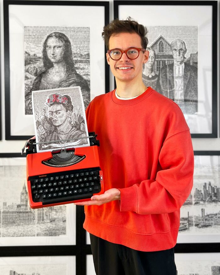 Young artist holding a typewriter with detailed typewriter art, framed typewriter drawings visible in the background.