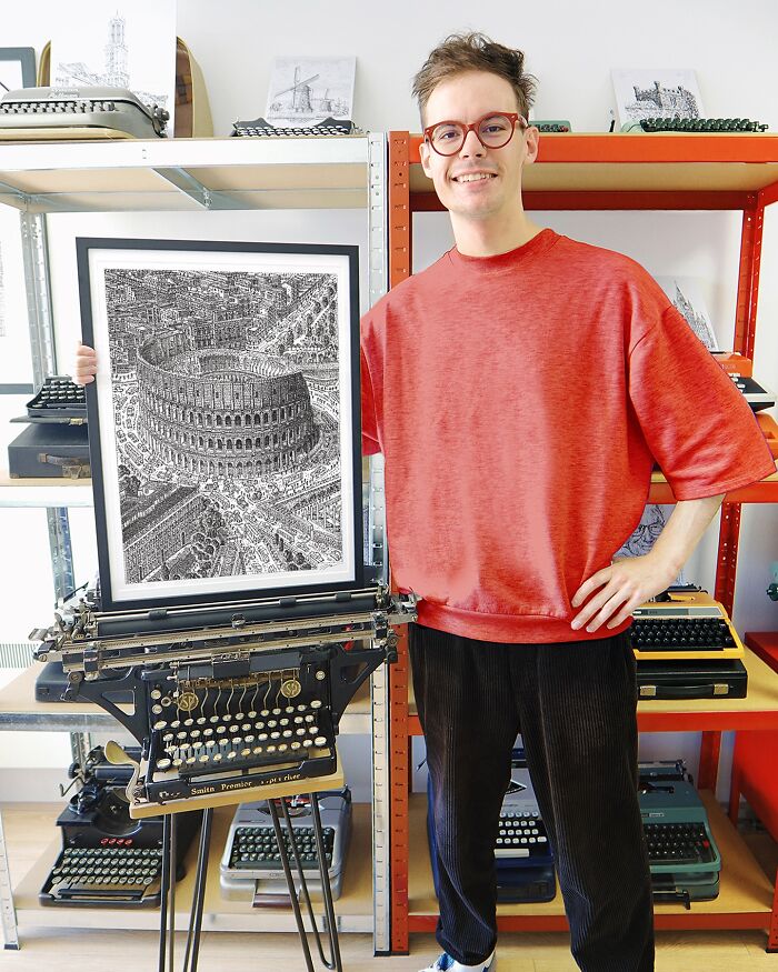 Young artist displaying detailed typewriter drawing of a Coliseum, surrounded by vintage typewriters on shelves.