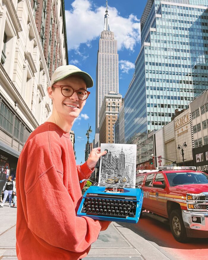 Young artist holding a blue typewriter and detailed cityscape drawing with skyscrapers in a busy urban street.