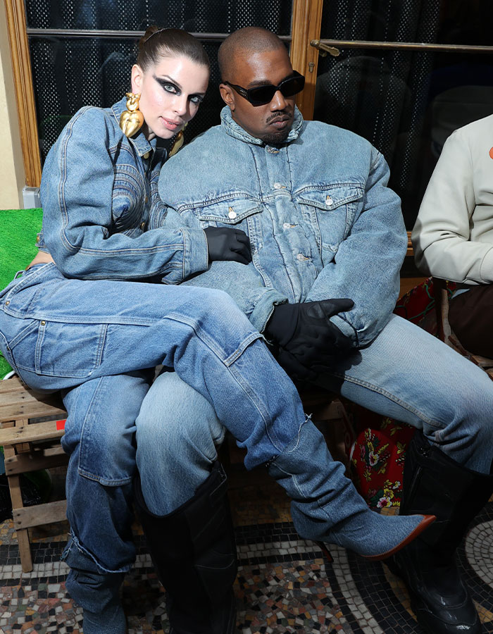Julia Fox wearing denim with Kanye West at an event, known for flashing her bloody period underwear.