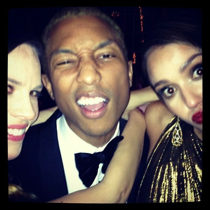 Three celebrities posing closely together at a party, sharing a candid Instagram moment from way back in the day.