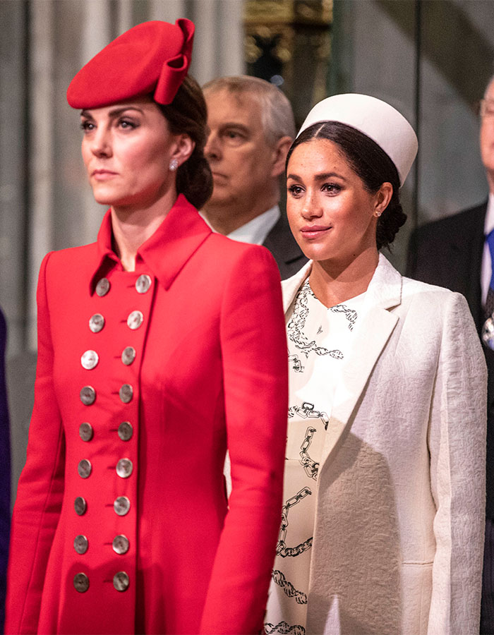 Kate Middleton wearing red coat and hat with Meghan Markle in white coat and hat at a formal event, highlighting clash details revealed.