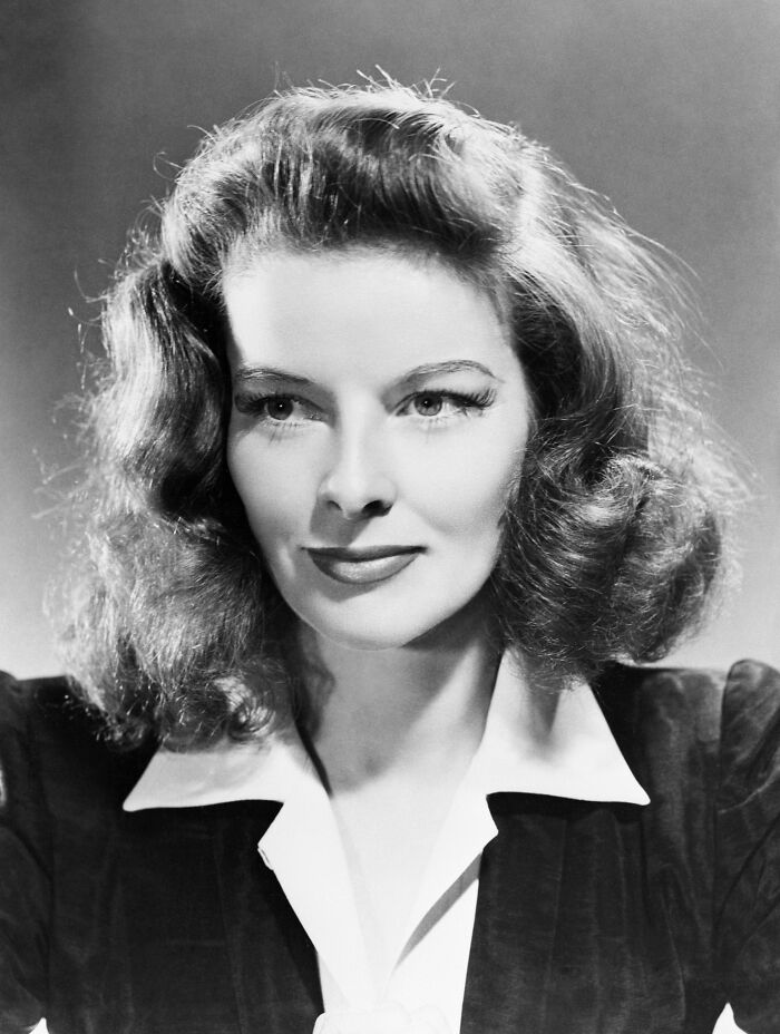 Black and white portrait of a glamorous 1940s Hollywood icon with wavy hair and classic vintage style.
