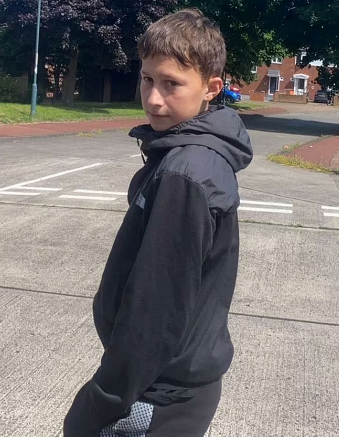 Boy standing on a street wearing a black jacket, related to children arrested after missing boy's body found in industrial park fire. Boy standing on a street wearing a black jacket, related to children arrested after missing boy's body found in industrial park fire.