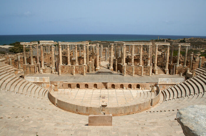 Ancient Roman amphitheater ruins by the sea, showcasing stunning UNESCO treasures and historic architectural columns.